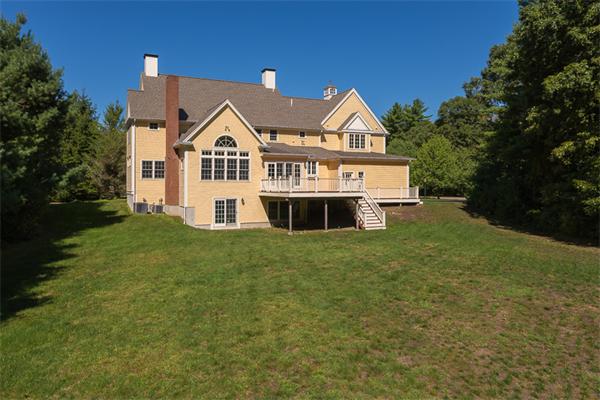 108 Deerfield Lane Hanover, MA 02339 - Photo 28 of 28 a view of a house next to a big yard and large trees