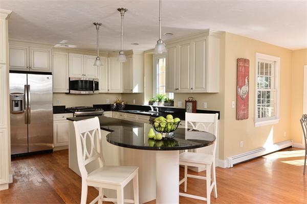 108 Deerfield Lane Hanover, MA 02339 - Photo 5 of 28 a kitchen with a refrigerator a stove a sink and white cabinets