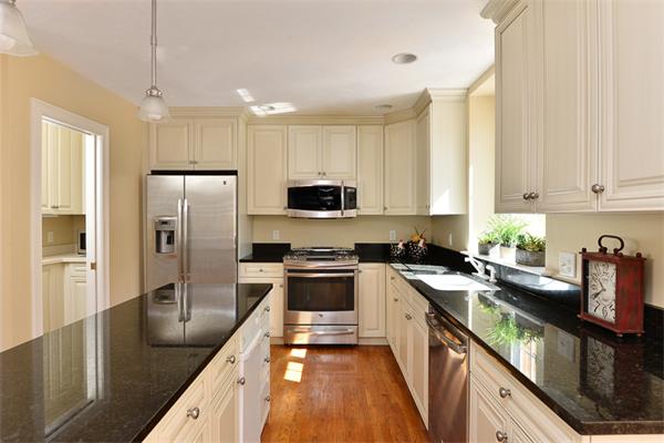 108 Deerfield Lane Hanover, MA 02339 - Photo 6 of 28 a kitchen with granite countertop a refrigerator a sink a stove and cabinets
