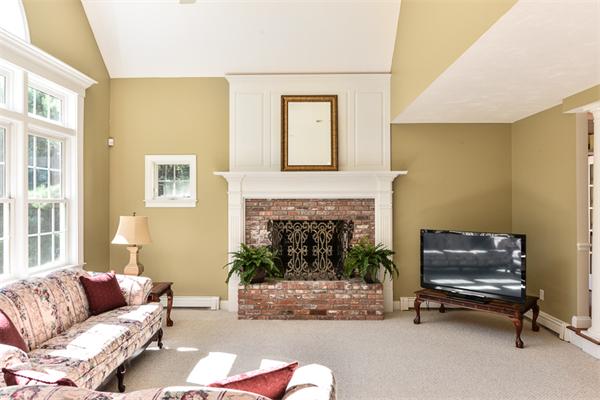 108 Deerfield Lane Hanover, MA 02339 - Photo 10 of 28 a living room with furniture and a fireplace