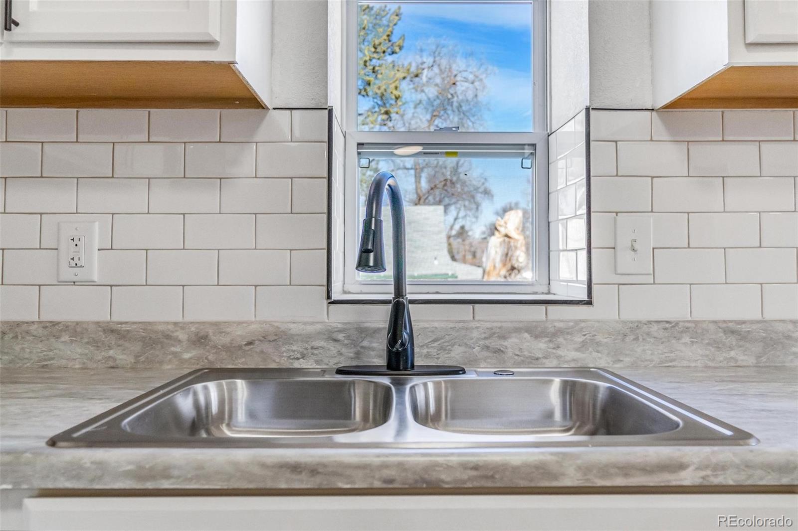 350 South Elbert Street Elizabeth, CO 80107 - Photo 16 of 22 a kitchen with a sink and cabinets