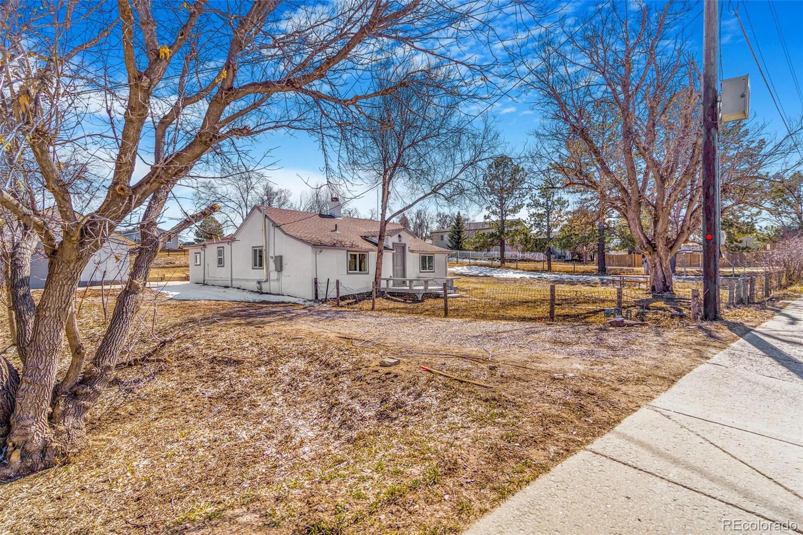 350 South Elbert Street Elizabeth, CO 80107 - Photo 3 of 22 a view of a yard with large trees