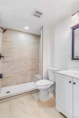 a bathroom with a toilet and a shower