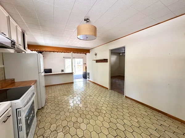 a kitchen with granite countertop white cabinets and stainless steel appliances