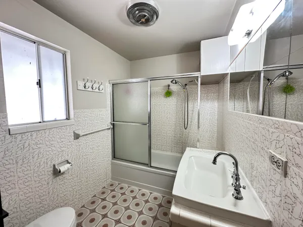 a bathroom with a sink toilet and shower
