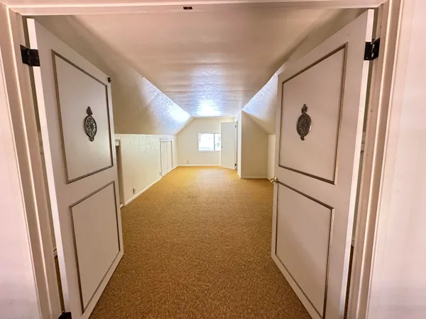 a bathroom with a shower and a door