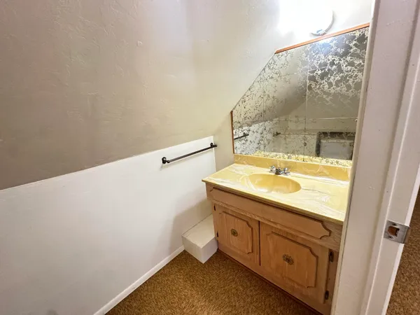 a bathroom with a sink and mirror