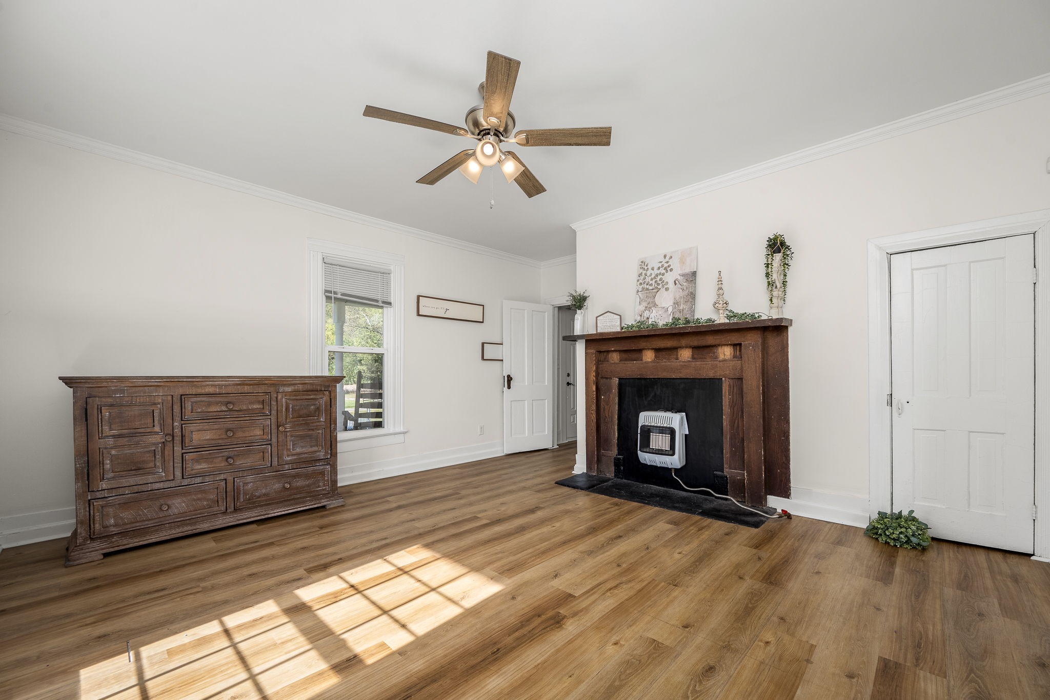 2180 Polly Adams Road Petersburg, TN 37144 - Photo 14 of 57 a view of an empty room with wooden floor fireplace and a window