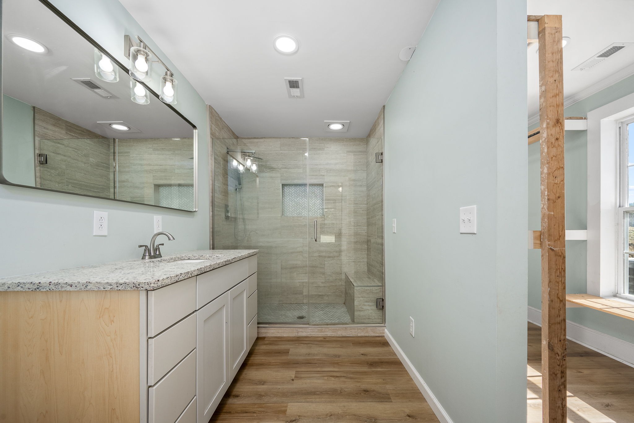 2180 Polly Adams Road Petersburg, TN 37144 - Photo 16 of 57 a bathroom with a granite countertop sink a large mirror and shower