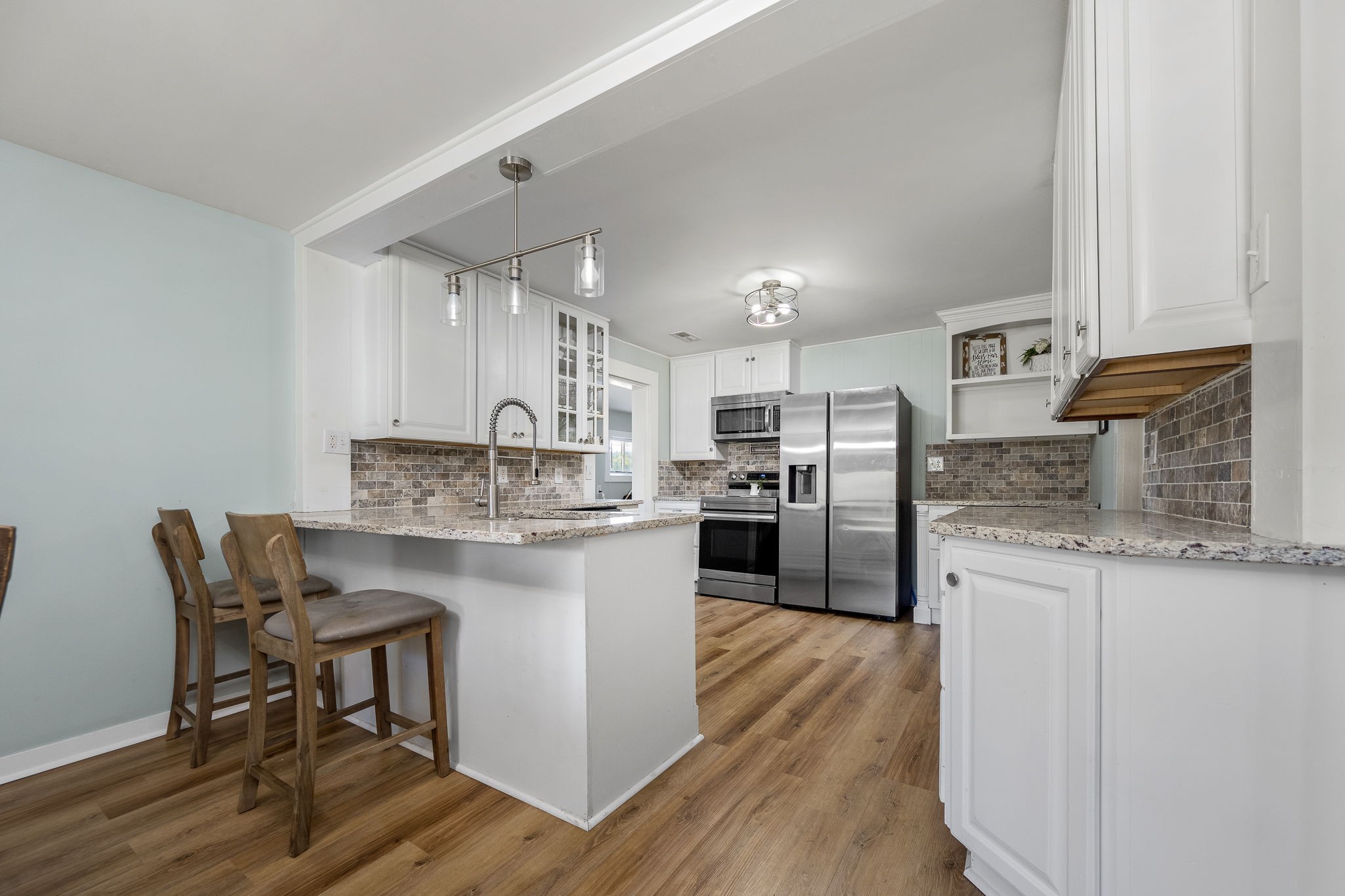 2180 Polly Adams Road Petersburg, TN 37144 - Photo 23 of 57 a kitchen with stainless steel appliances granite countertop a white cabinets and wooden floor