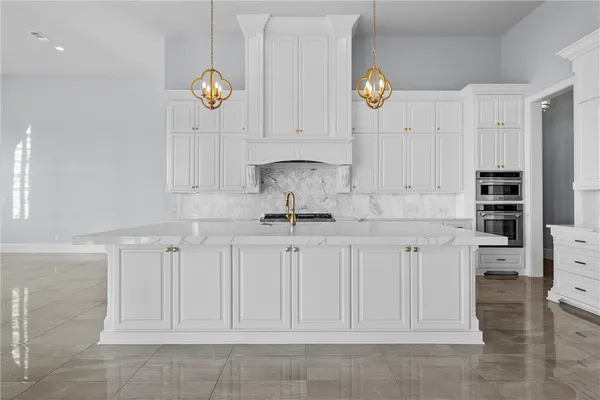 a kitchen with stainless steel appliances granite countertop a stove and a sink