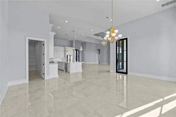 a kitchen with granite countertop white cabinets and window