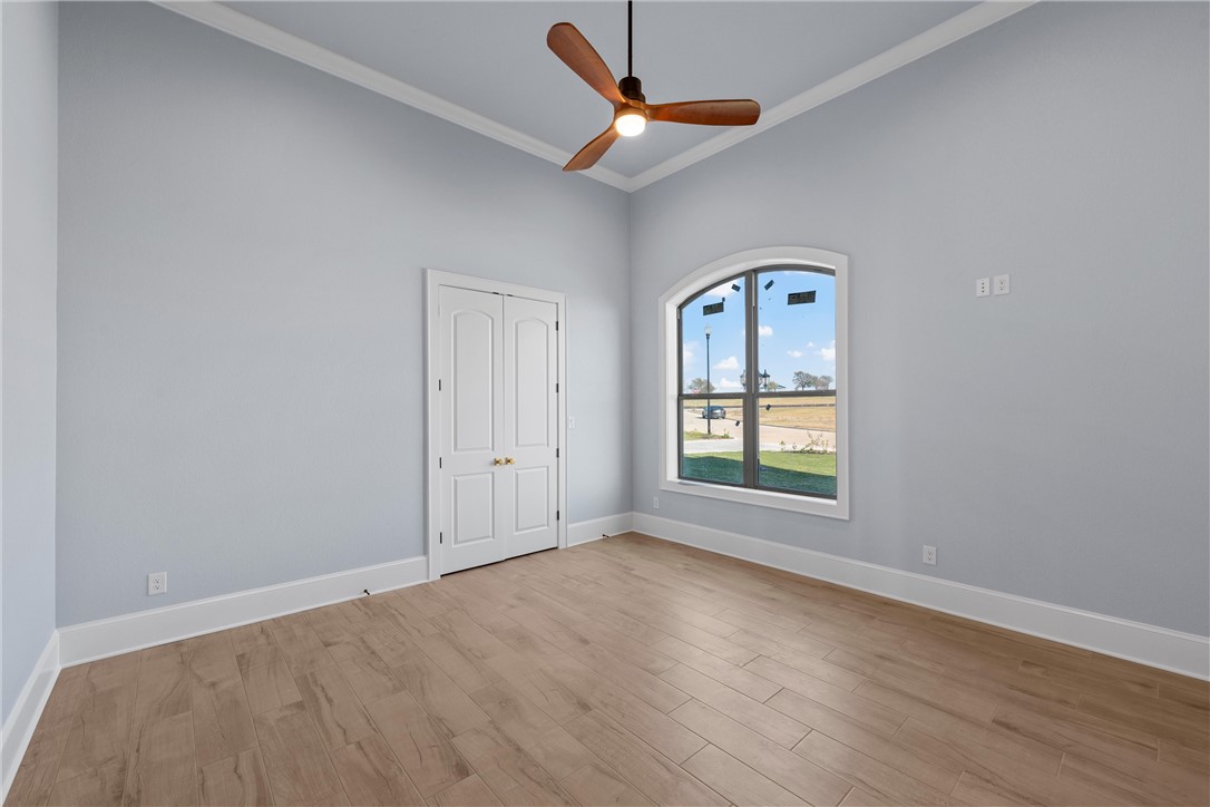 129 Iris Street Lorena, TX 76655 - Photo 29 of 56 an empty room with a window and wooden floor