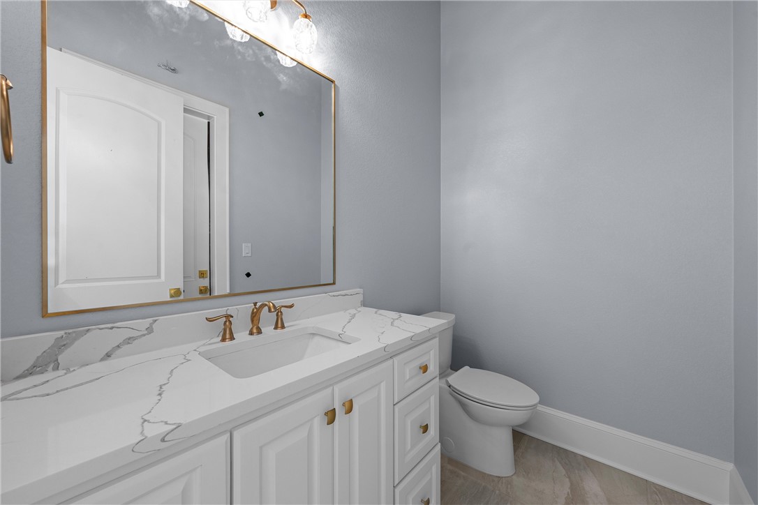 129 Iris Street Lorena, TX 76655 - Photo 30 of 56 a bathroom with a sink toilet and vanity