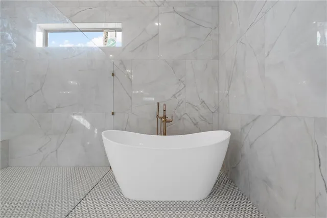 a large bathroom with a large tub shower and sink
