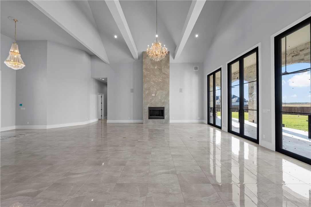 129 Iris Street Lorena, TX 76655 - Photo 8 of 56 a view of an empty room with a fireplace and a large window