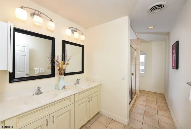 a bathroom with a double vanity sink mirror and