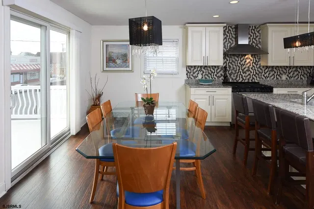 a dining room with furniture and wooden floor