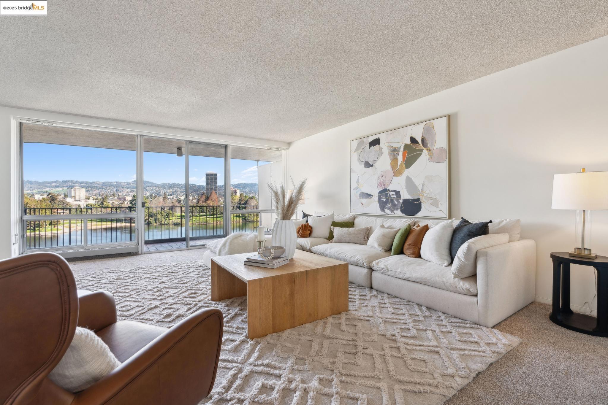 177 19th Street, Unit 5A Oakland, CA 94612 - Photo 1 of 49 a living room with furniture wooden floor and a large window