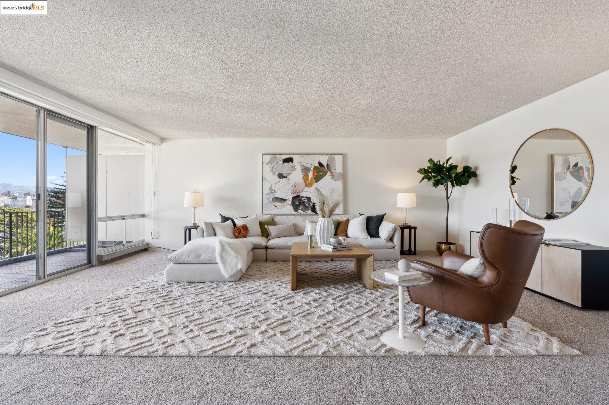 177 19th Street, Unit 5A Oakland, CA 94612 - Photo 11 of 49 a living room with furniture a large window and a table