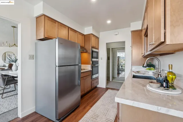 a kitchen with stainless steel appliances granite countertop a refrigerator and a sink