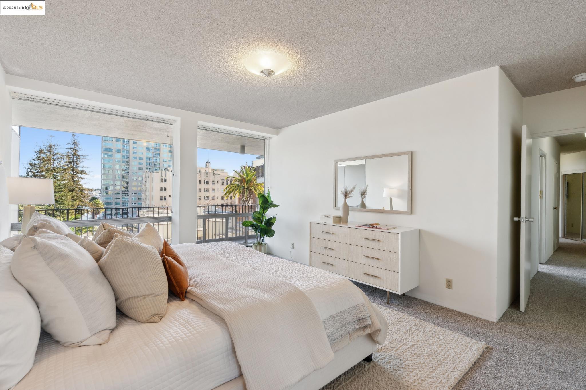 177 19th Street, Unit 5A Oakland, CA 94612 - Photo 26 of 49 a bedroom with a bed and a dresser