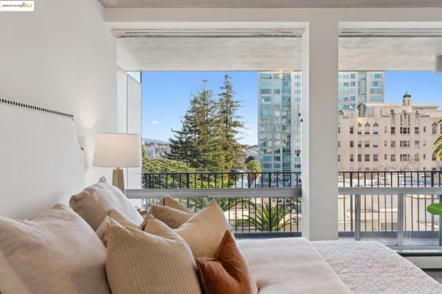 a living room with furniture and a floor to ceiling window