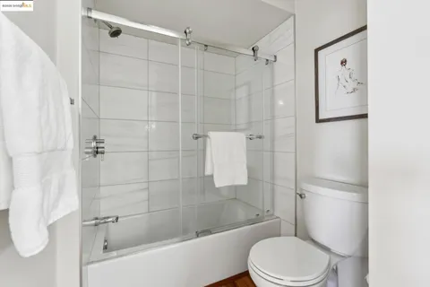 a bathroom with a toilet and shower