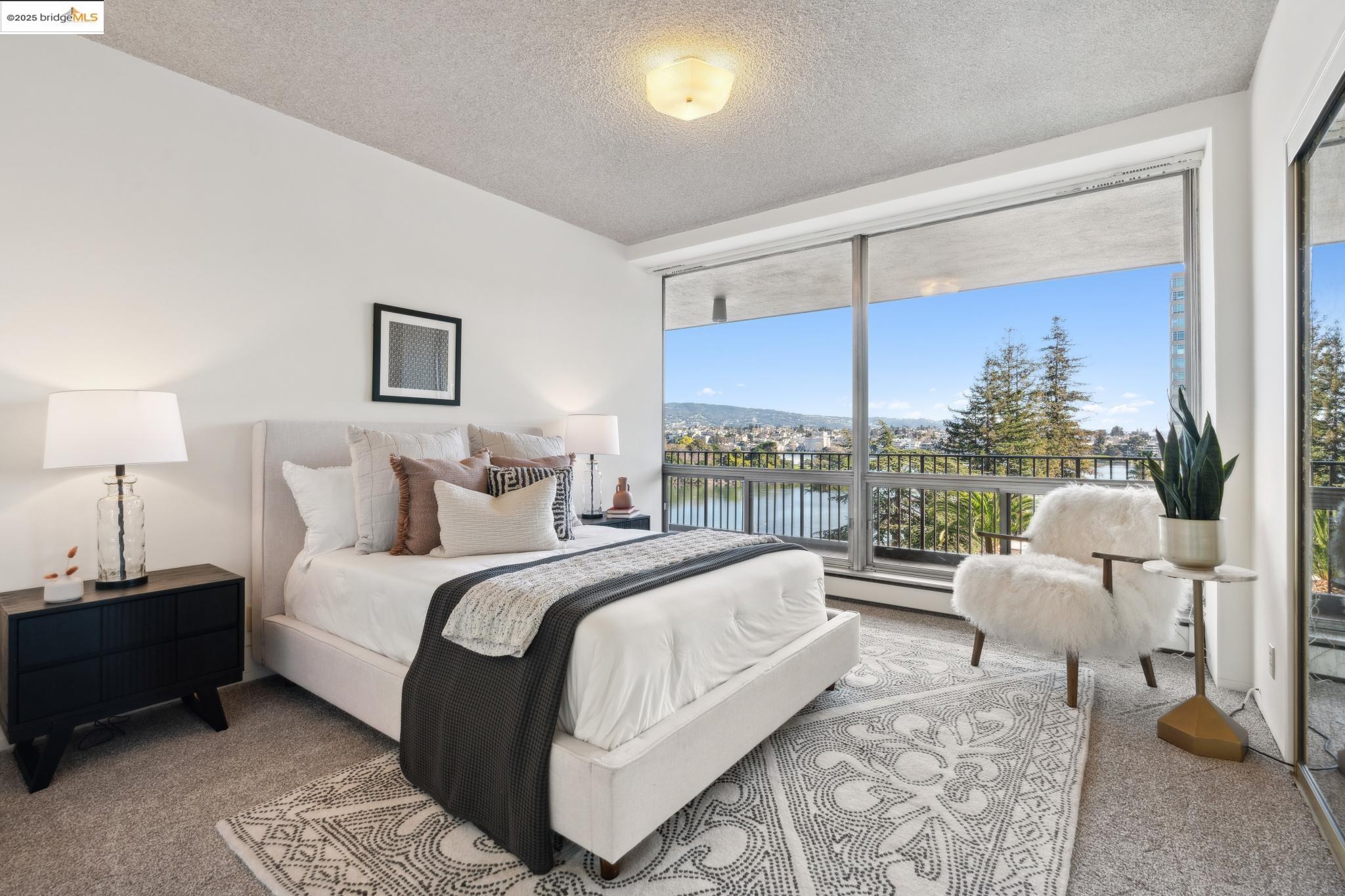 177 19th Street, Unit 5A Oakland, CA 94612 - Photo 31 of 49 a bedroom with a bed lamps and a large window