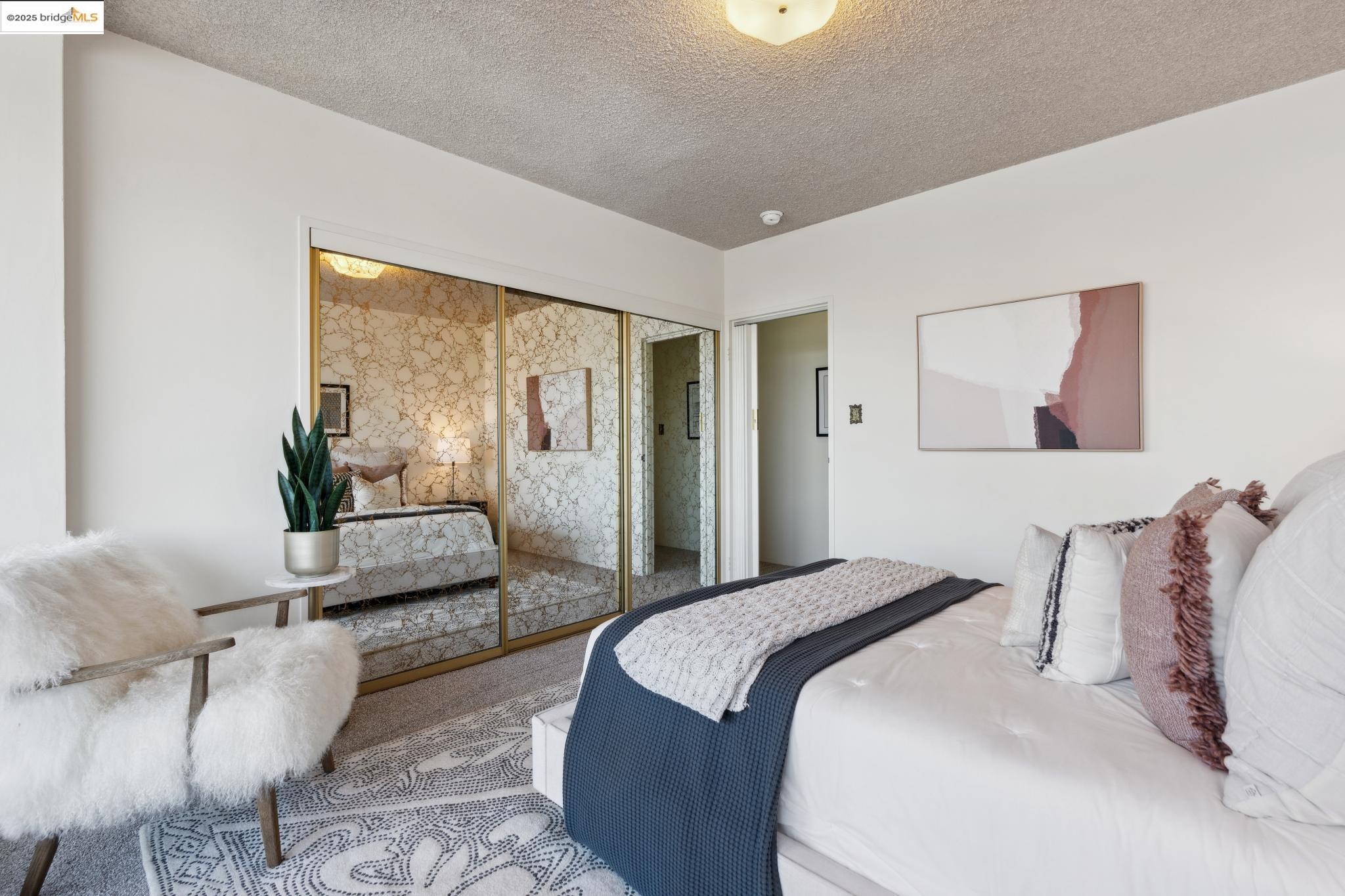 177 19th Street, Unit 5A Oakland, CA 94612 - Photo 32 of 49 a bedroom with a bed and a couch