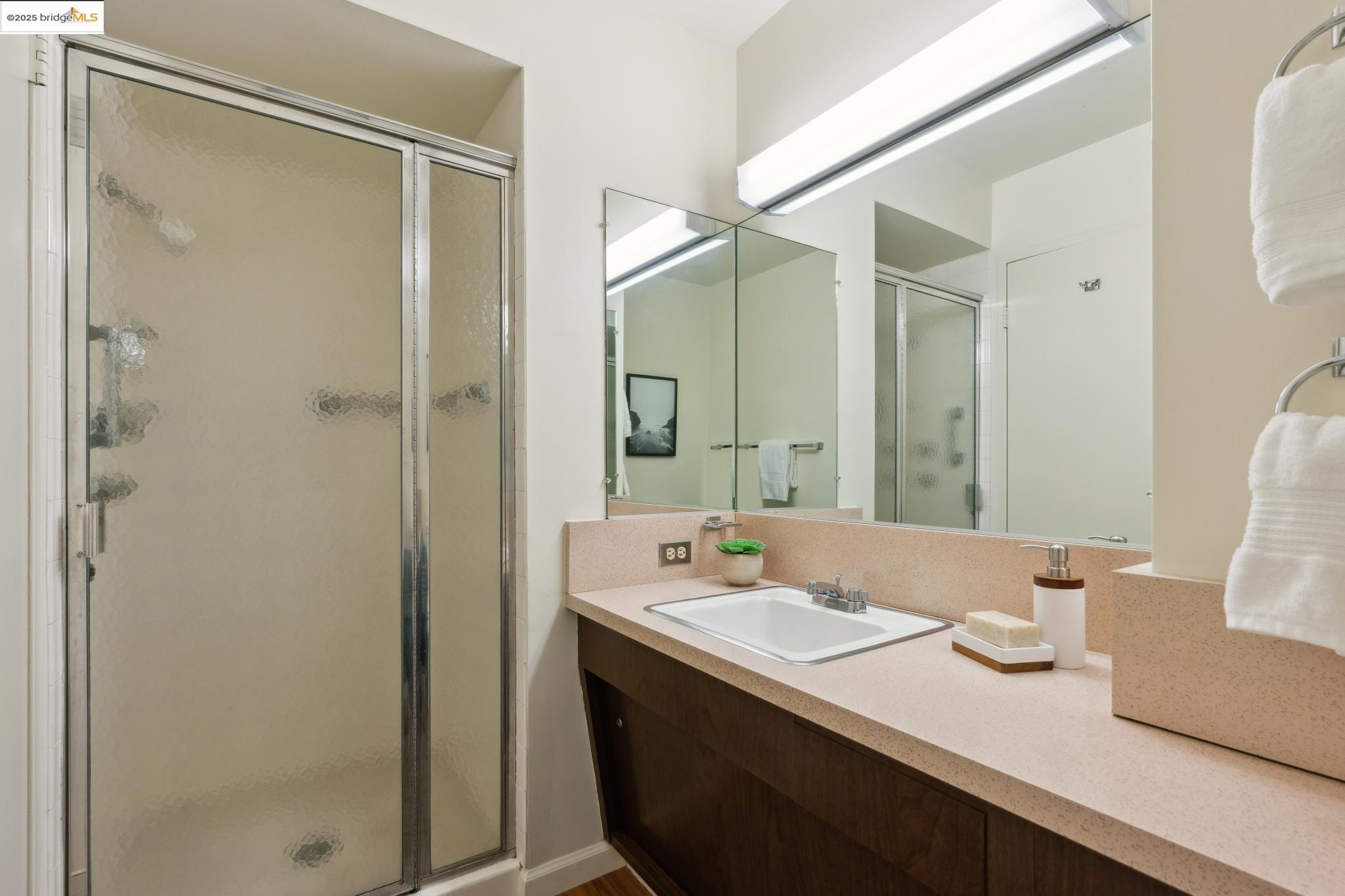 177 19th Street, Unit 5A Oakland, CA 94612 - Photo 33 of 49 a bathroom with a sink and a mirror