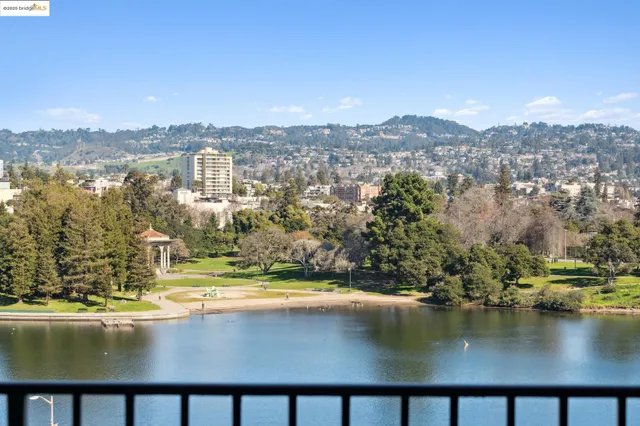 an aerial view of residential houses with outdoor space and lake view