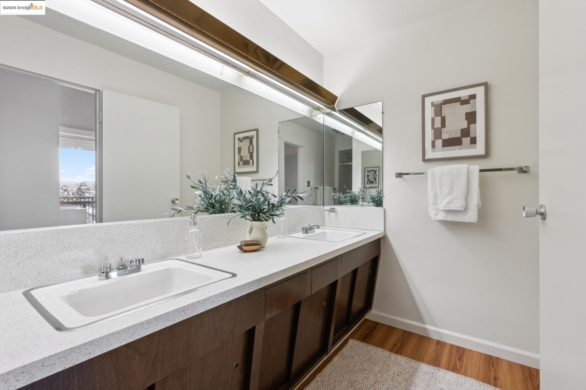 177 19th Street, Unit 5A Oakland, CA 94612 - Photo 38 of 49 a bathroom with a sink and a mirror