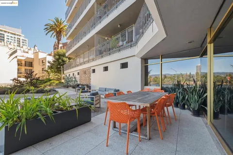 a outdoor dining space with furniture and potted plants