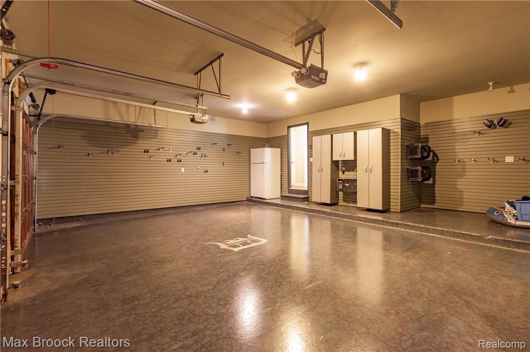 242 Aspen Road Birmingham, MI 48009 - Photo 50 of 55 Even the Garage is Beautifully Finished with Storage Cabinets on Two Walls and Epoxy Floor. Best of All it is an Attached Garage!