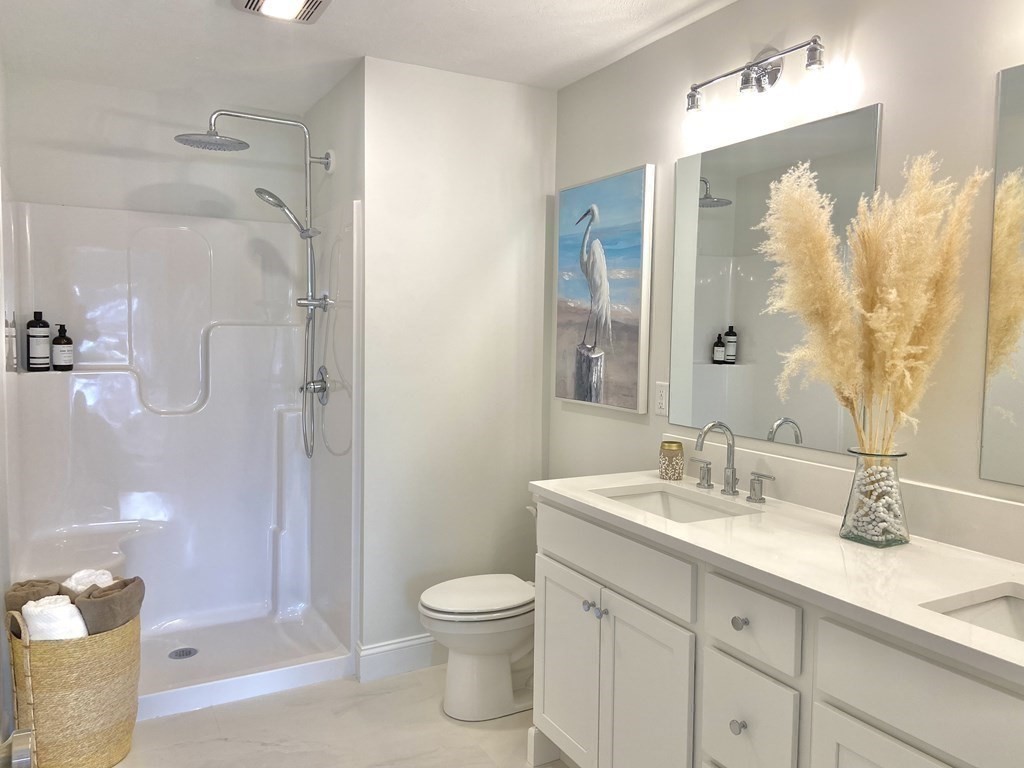 20 Sandy Pond Road, Unit 20 Ayer, MA 01432 - Photo 17 of 25 a bathroom with a sink a toilet and shower
