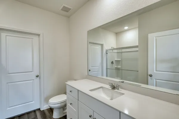 a bathroom with a sink toilet and shower