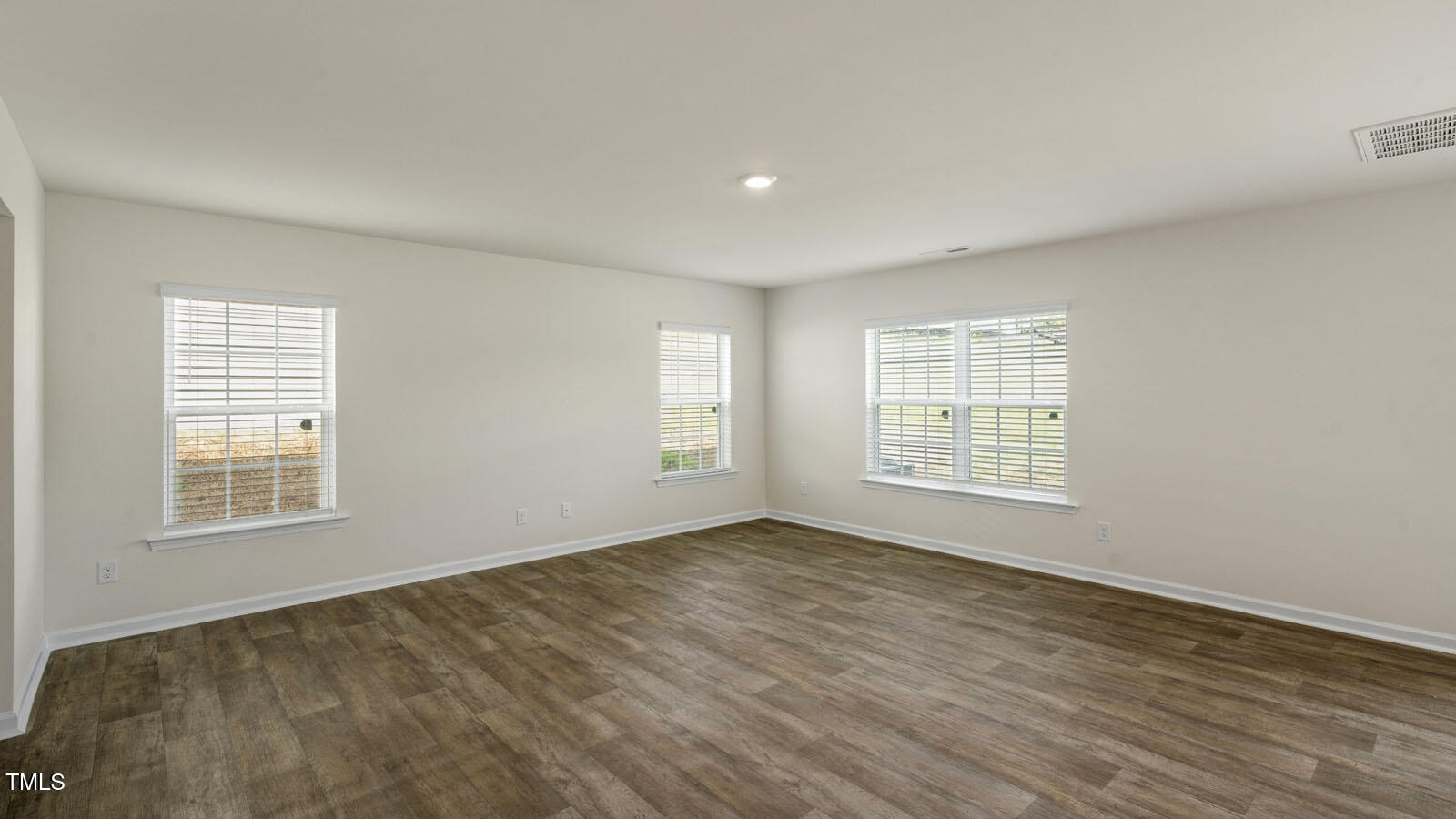 6016 Sodium Street Raleigh, NC 27610 - Photo 19 of 22 a view of an empty room with wooden floor and a window