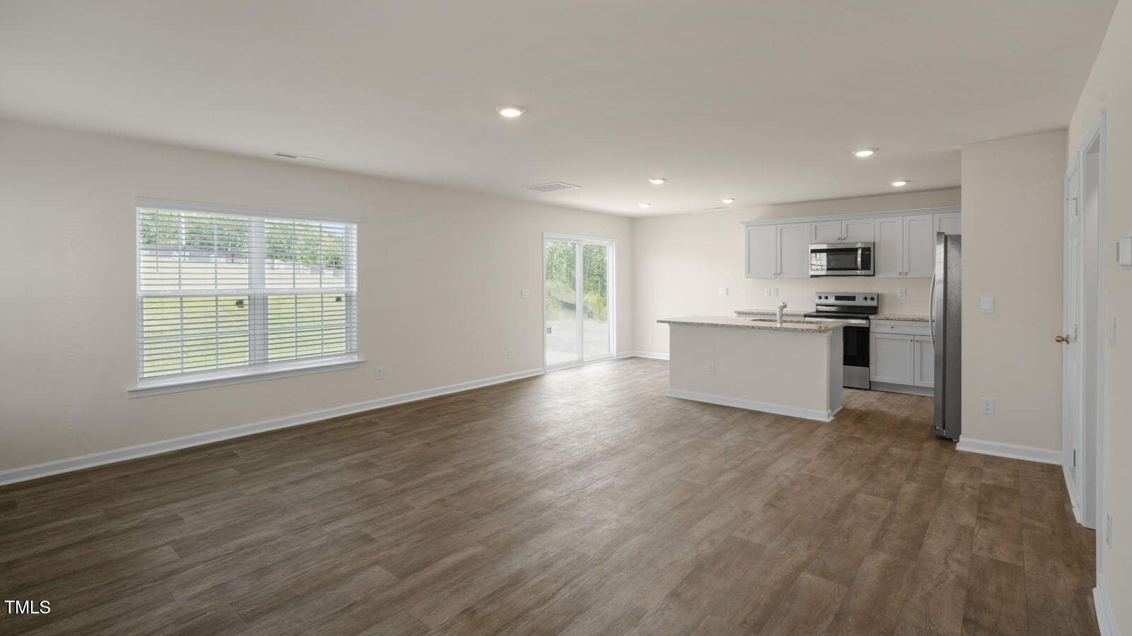 6016 Sodium Street Raleigh, NC 27610 - Photo 4 of 22 a view of kitchen with wooden floor electronic appliances and window