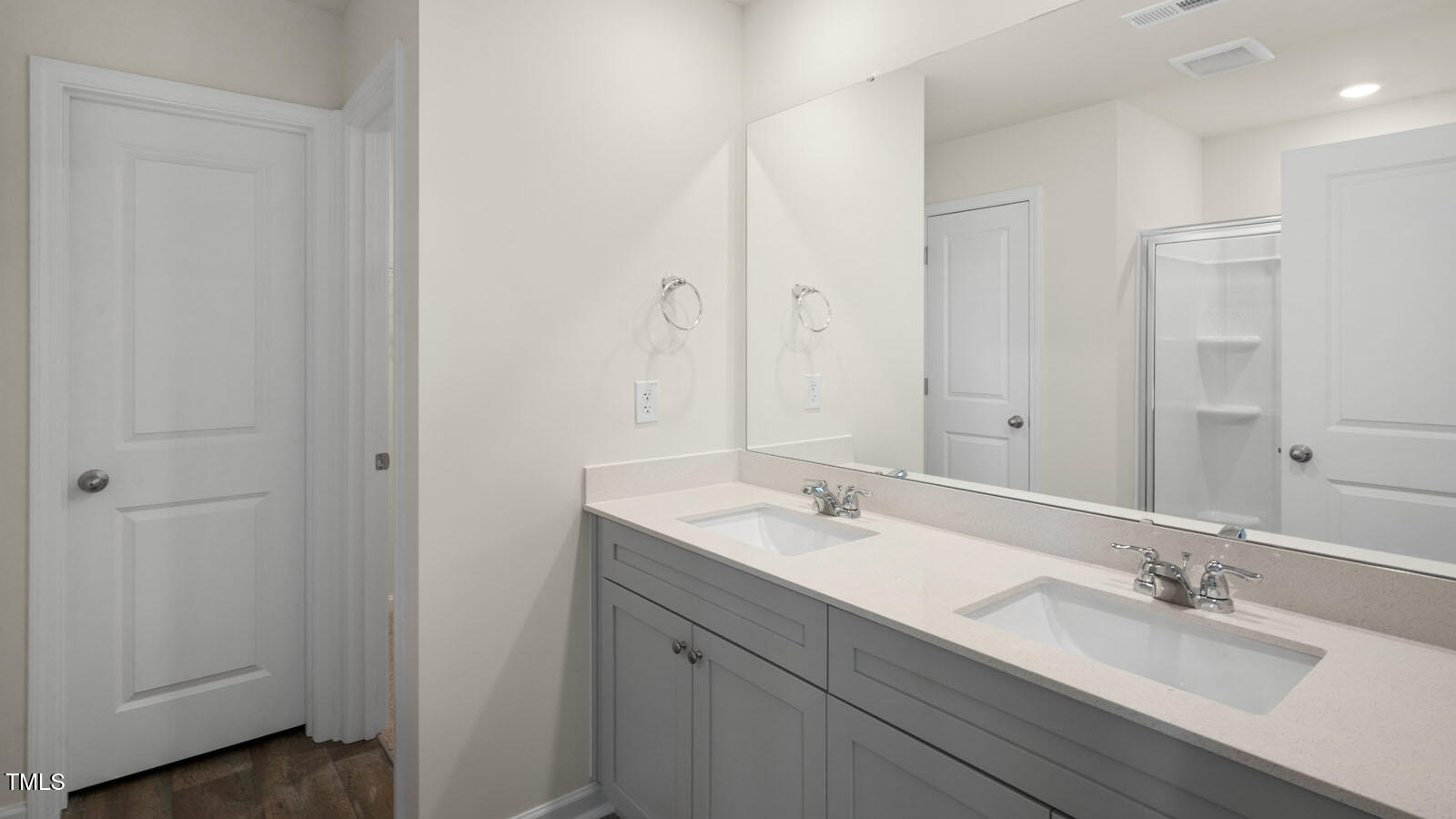 6016 Sodium Street Raleigh, NC 27610 - Photo 9 of 22 a bathroom with a double vanity sink and mirror