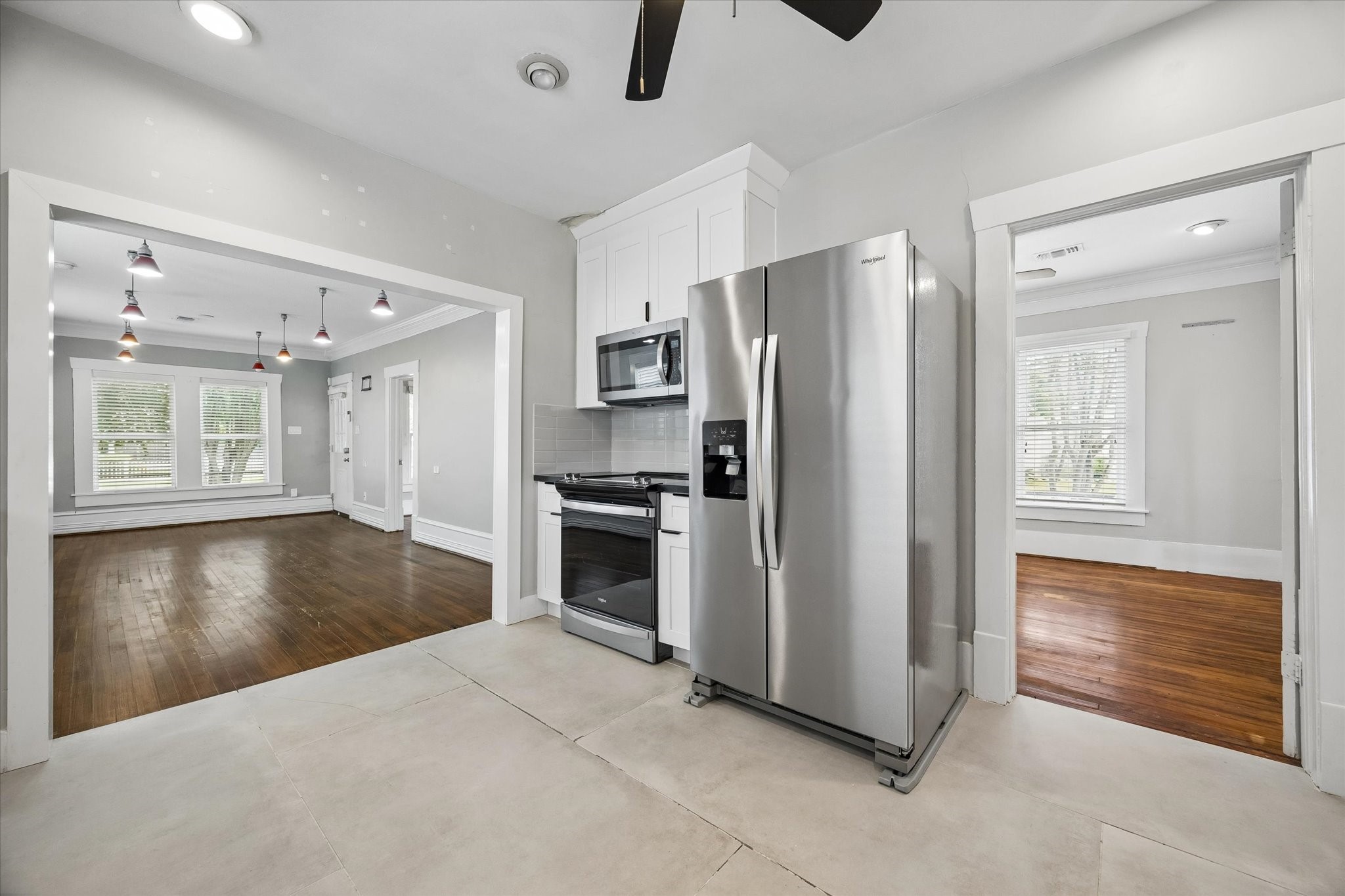 1201 Tulane Street Houston, TX 77008 - Photo 16 of 31 The kitchen sits right at the center of the home, keeping the living and dining areas connected while still giving you a bright, functional place to cook. Stainless steel appliances, crisp white cabinetry, granite countertops, and oversized tile flooring make this updated space feel fresh, practical, and easy to enjoy every day.
