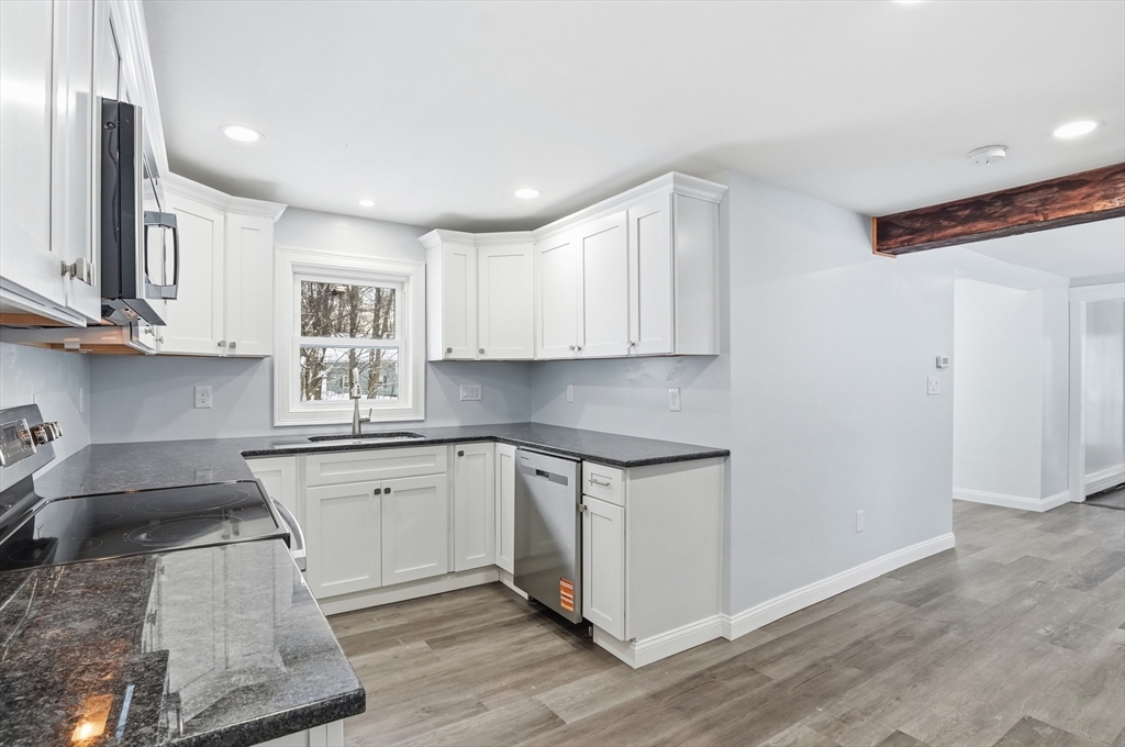 104 Temple Street Gardner, MA 01440 - Photo 12 of 40 a kitchen with stainless steel appliances granite countertop a sink and cabinets