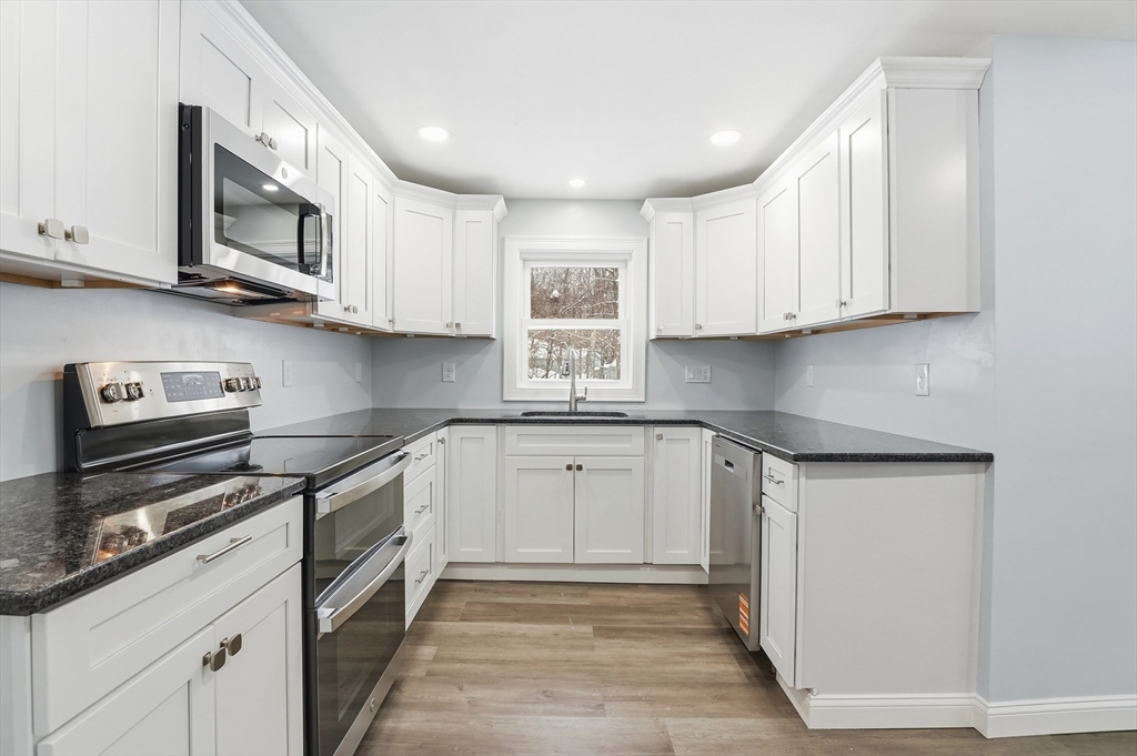 104 Temple Street Gardner, MA 01440 - Photo 13 of 40 a kitchen with stainless steel appliances granite countertop a sink and a stove