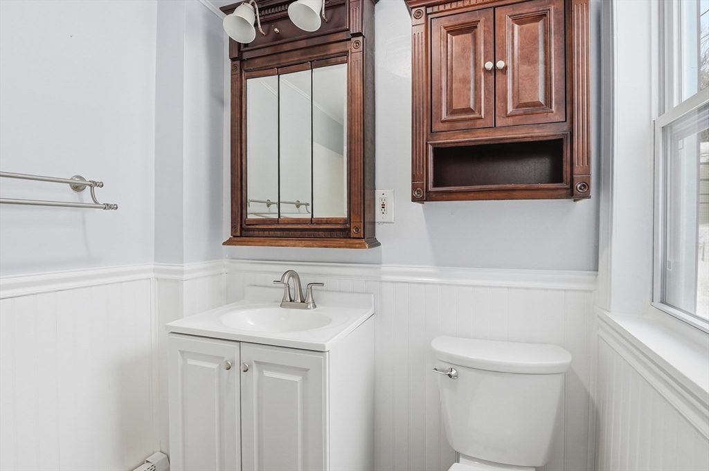 104 Temple Street Gardner, MA 01440 - Photo 20 of 40 a bathroom with a sink a toilet and a mirror