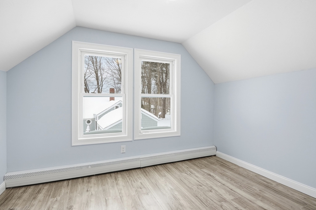 104 Temple Street Gardner, MA 01440 - Photo 29 of 40 an empty room with wooden floor and windows