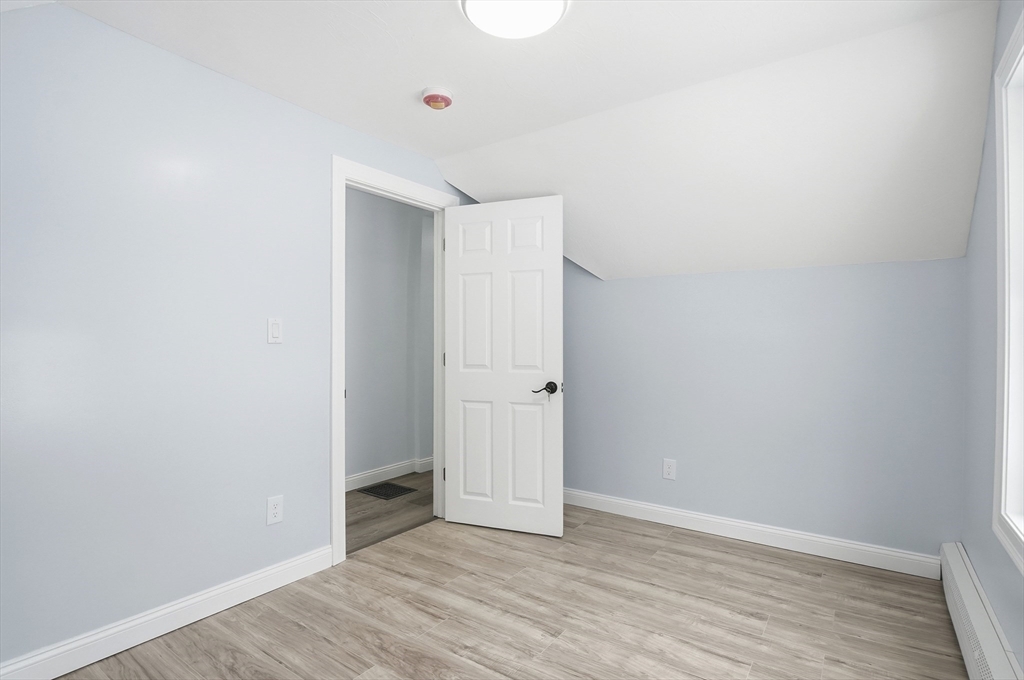 104 Temple Street Gardner, MA 01440 - Photo 31 of 40 a view of an empty room with wooden floor