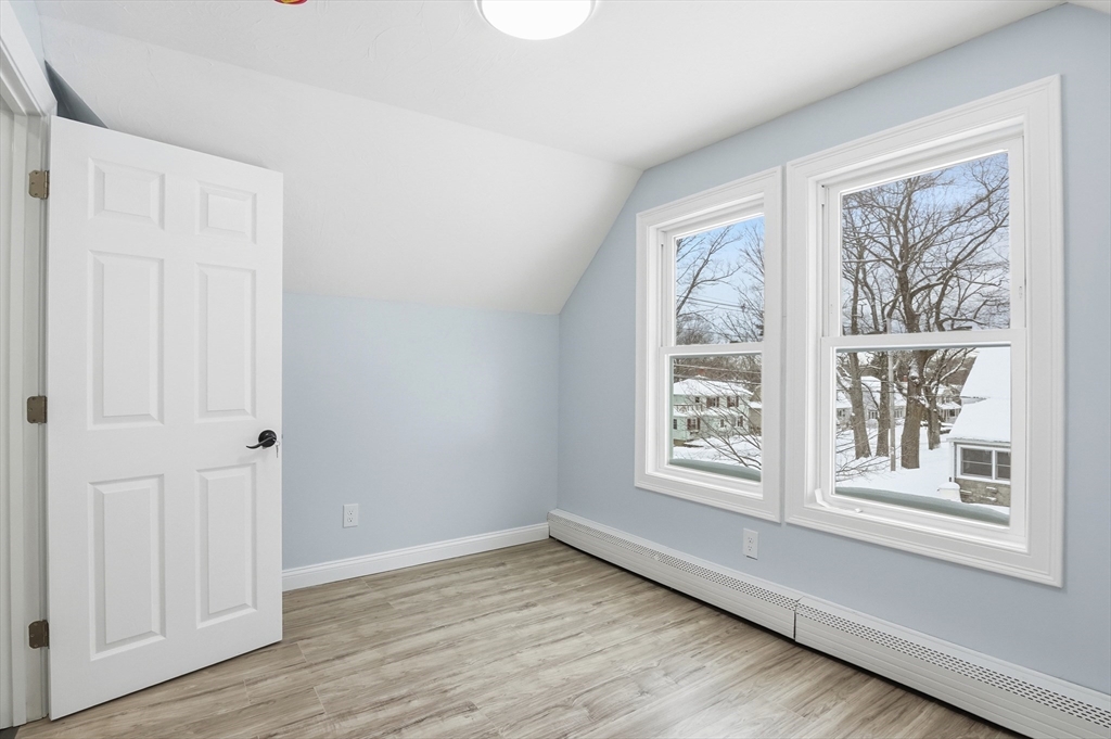 104 Temple Street Gardner, MA 01440 - Photo 32 of 40 a view of an empty room with wooden floor and a window