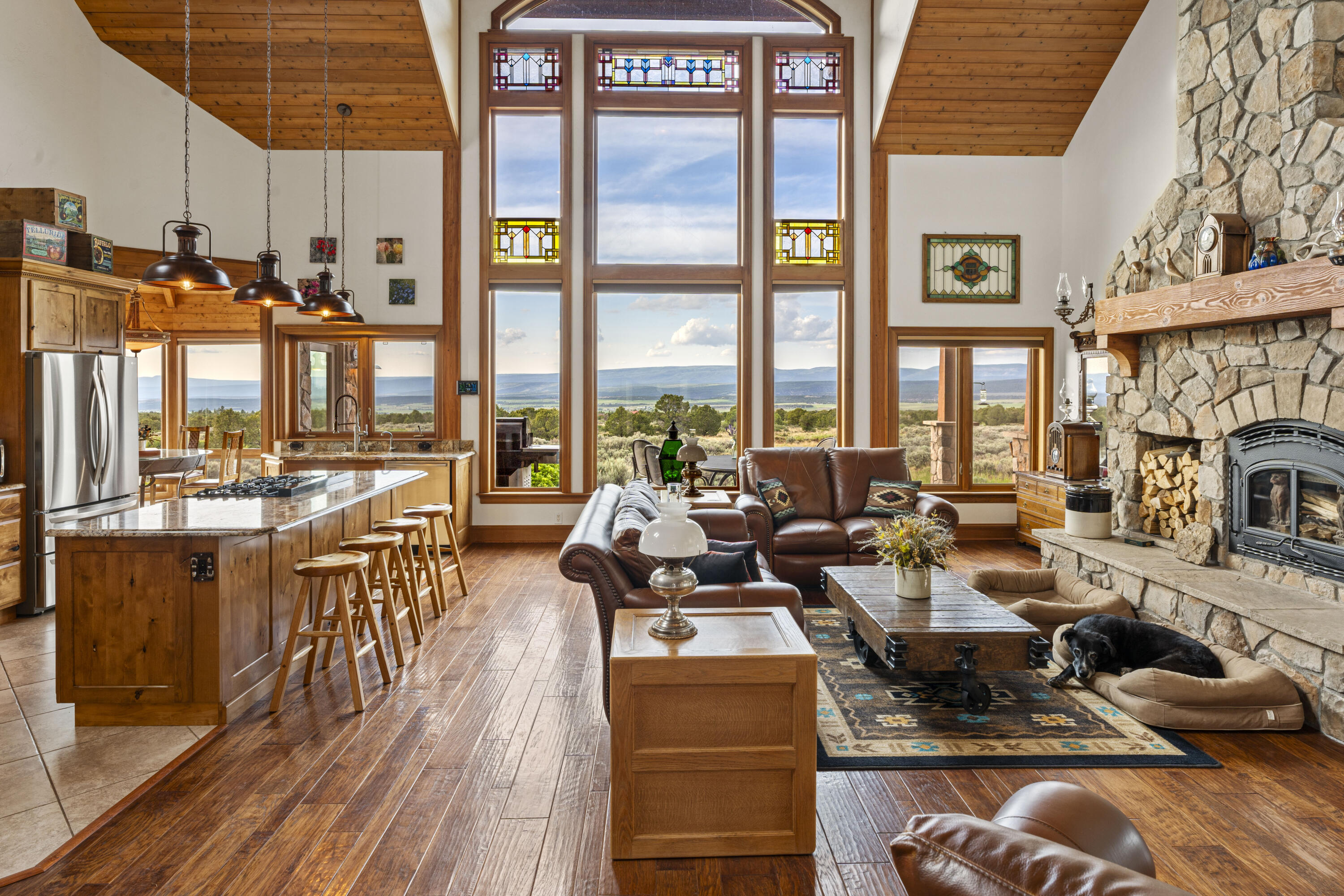 3100 South County Road Norwood, CO 81423 - Photo 14 of 44 a very nice looking living room with a large window and kitchen view