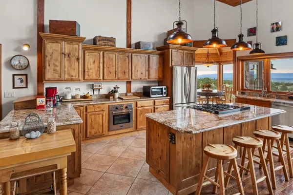 a kitchen with stainless steel appliances a sink stove and a refrigerator