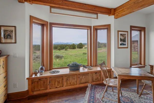 a living room with furniture and large windows